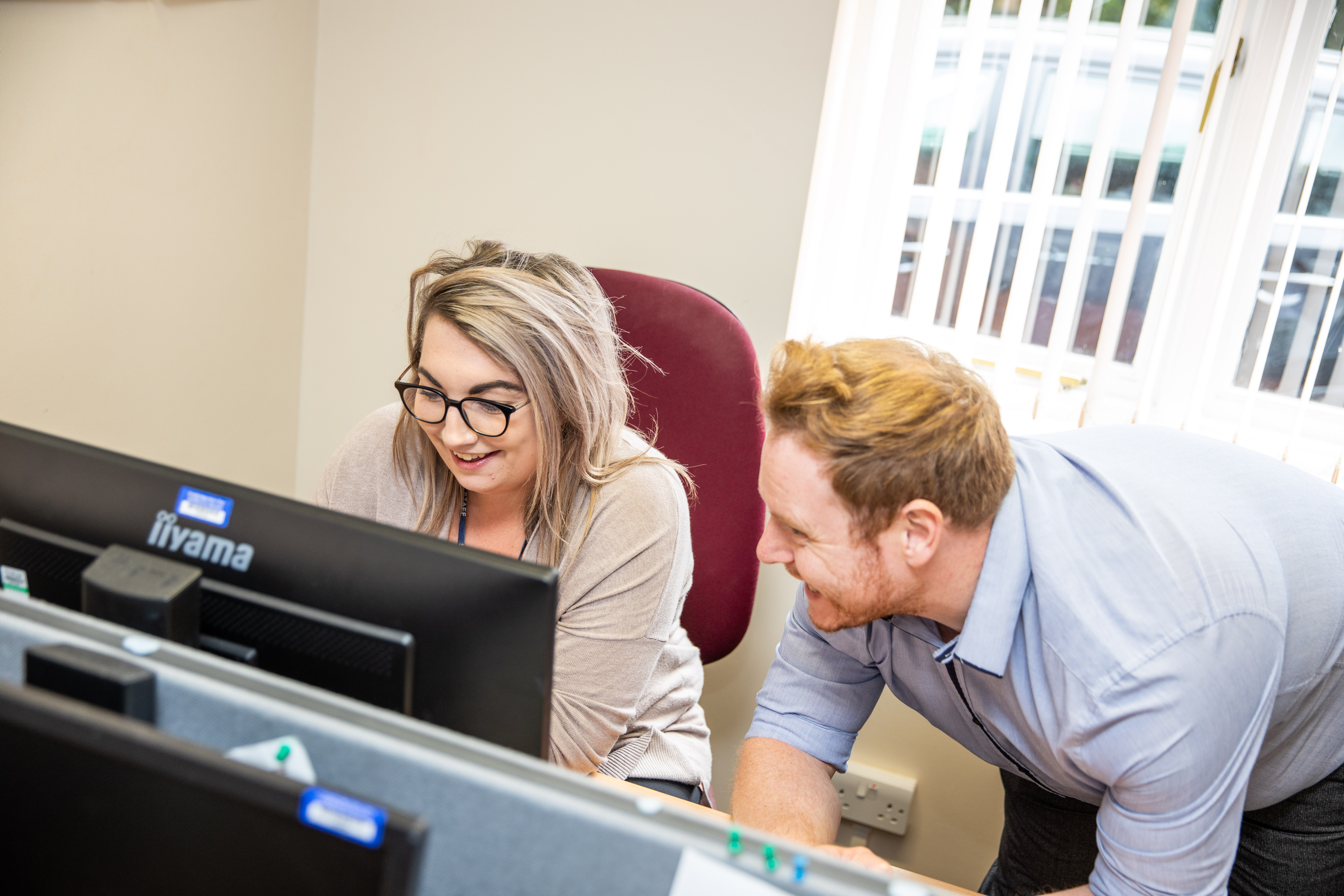 Two support staff at computer