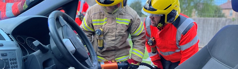 Firefighters training with car