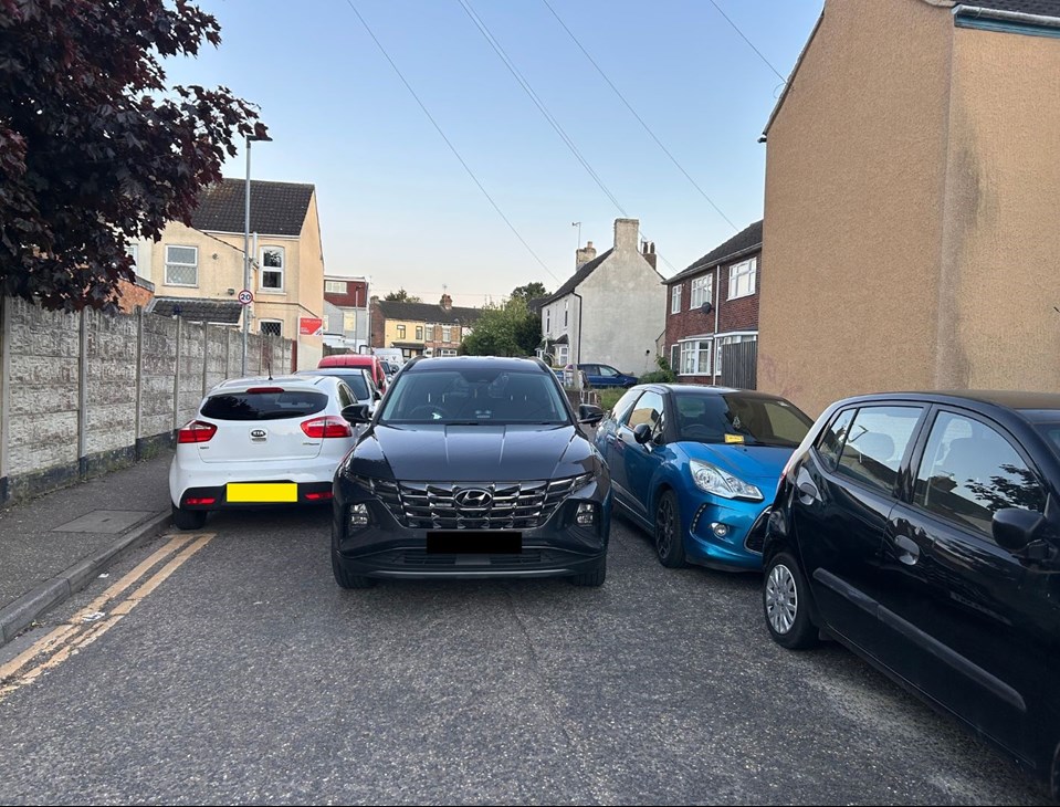 Car blocked by parked cars